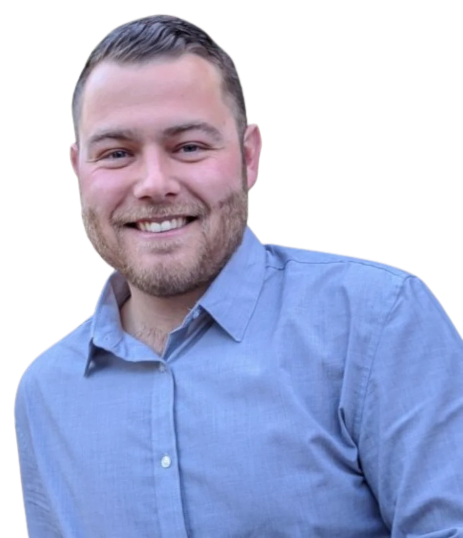 John White smiling in a blue button-down shirt